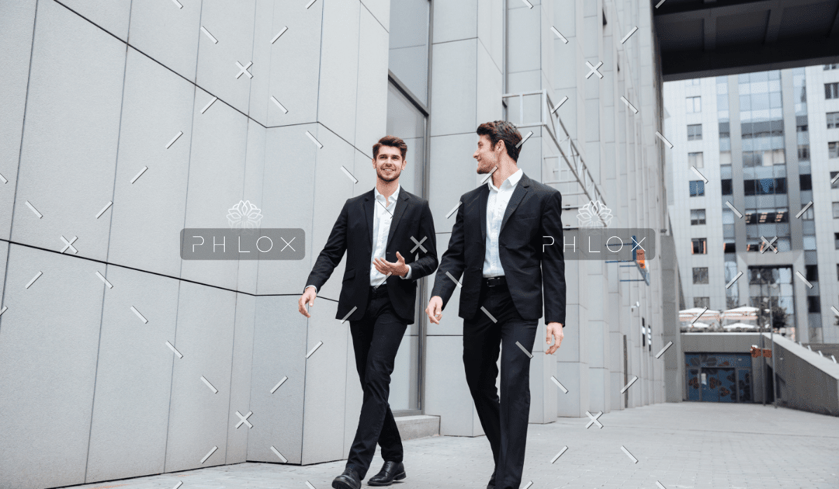 Two Businessmen Walking And Talking In The City PMW8E26